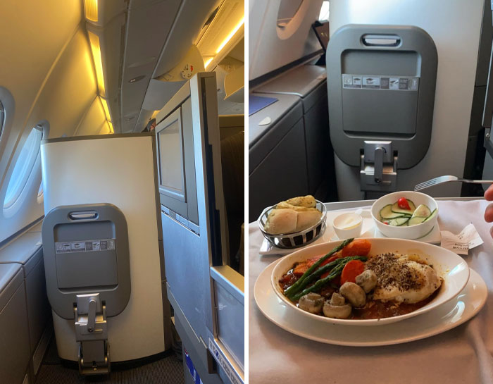 Airplane first-class seat with a meal tray featuring vegetables, bread, and fish, showcasing unbelievable luck travel experience.