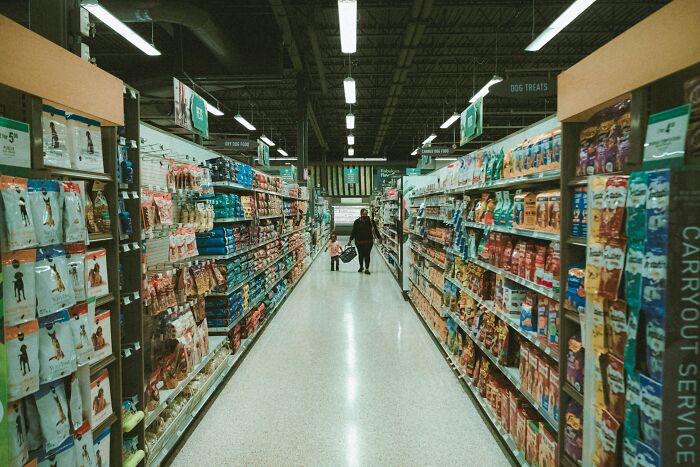 Night shift workers shopping in a brightly lit store aisle, showcasing benefits of working overnight shifts. - 25