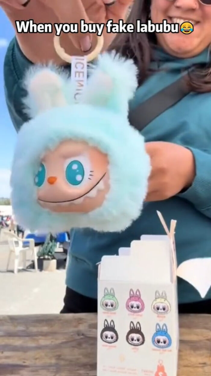 Person holding a fake Labubus keychain with a creepy face, showcasing one of the unsettling Labubus fakes.