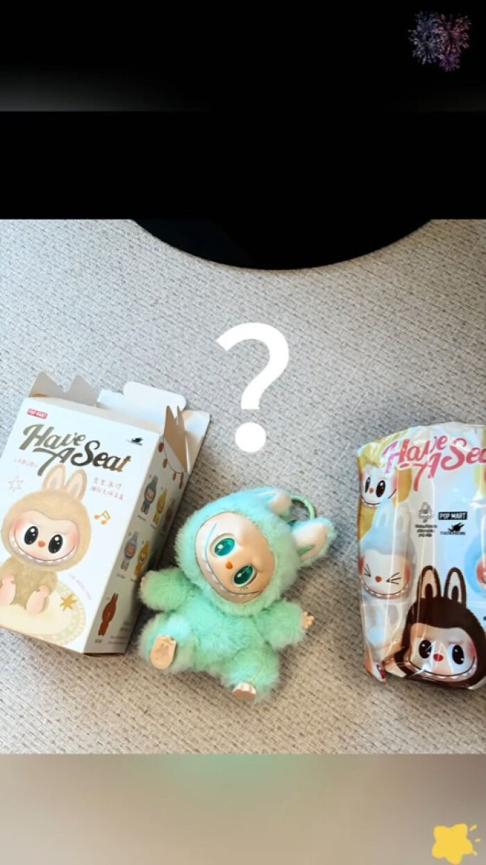 Plush toy resembling Labubus character in green costume with its original box and packaging on carpet background.