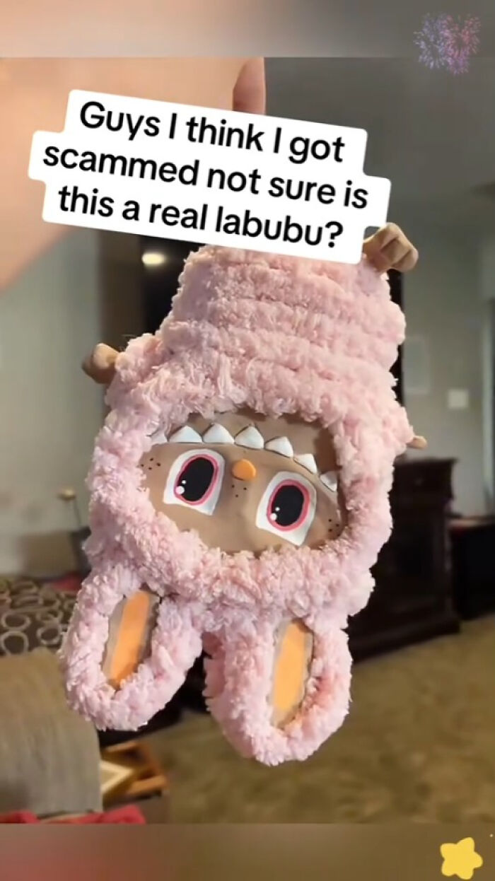 Plush pink Labubu fake doll with large eyes held in hand, raising questions about Labubu fakes and nightmares.