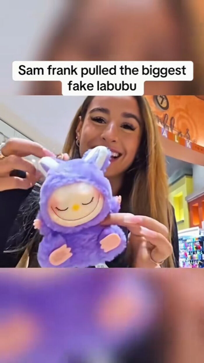 A woman holds a purple fake Labubu doll with a smiling face, showcasing one of the creepy Labubu fakes.