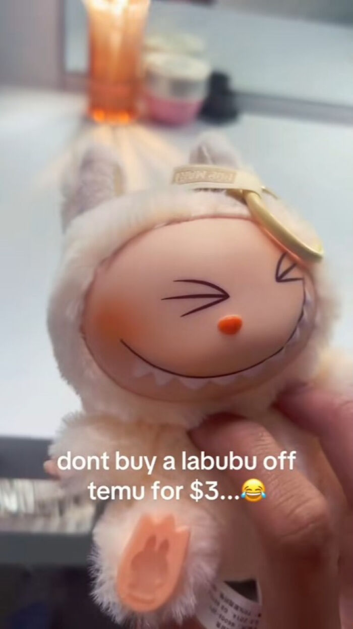 Plush Labubu keychain with a creepy smile held by hand, representing fake Labubu toys that give nightmares.
