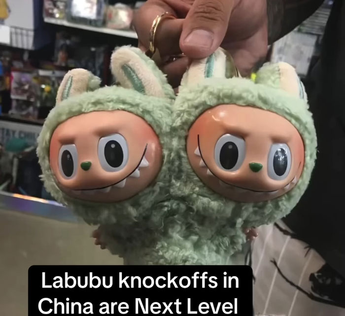 Two-headed Labubu knockoff toys with creepy expressions held by a person in a store, showcasing fake Labubus.
