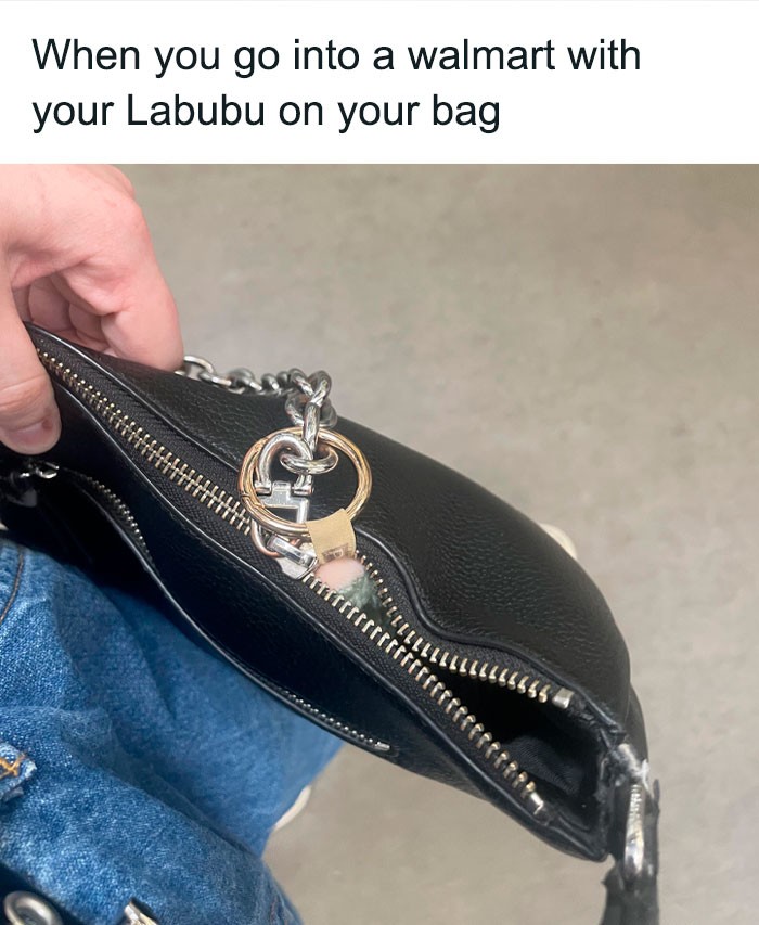 Hand holding black purse with a Labubu doll keychain partially visible inside, sparking hilarious Labubu memes online.