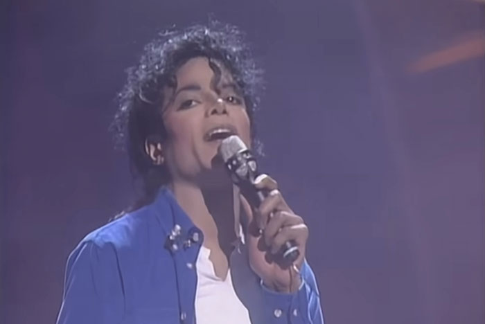 Singer performing on stage holding a microphone, relating to lawyers and defendants failing miserably in court.