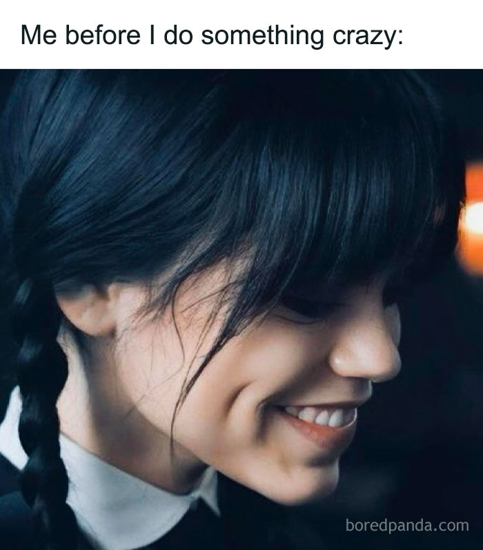 Young woman with braided hair smiling subtly, relatable meme expression for totally random memes about unexpected feelings.