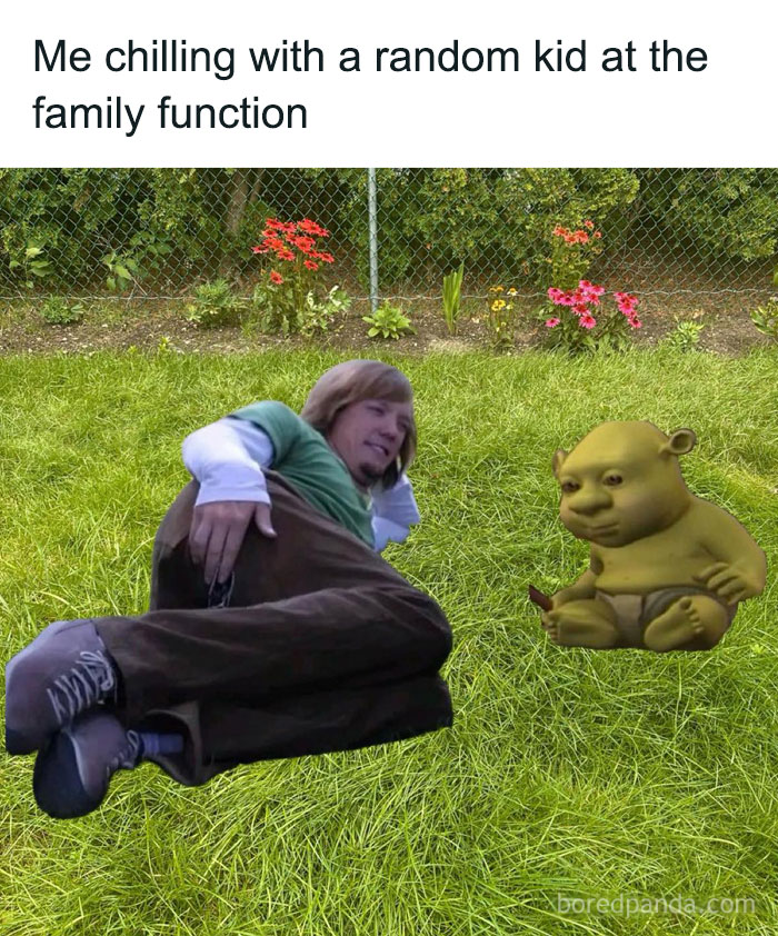 Person lying on grass next to a cartoon baby ogre, illustrating a relatable random meme at a family function outdoors.