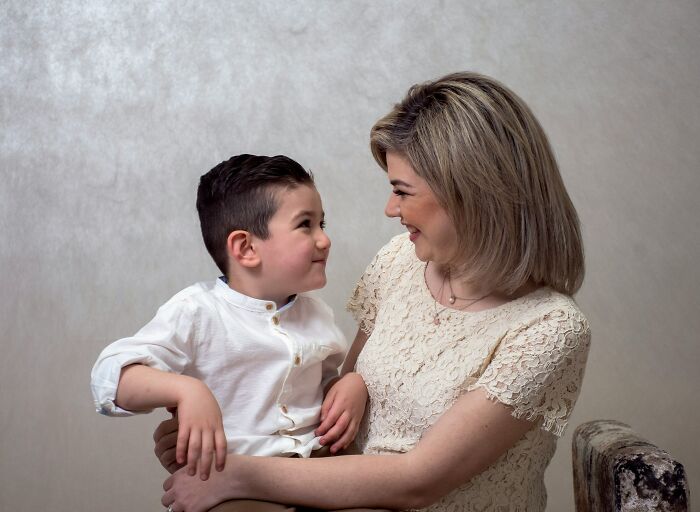 A smiling mother holding her son closely, illustrating emotions that can mask relationship red flags. - 2