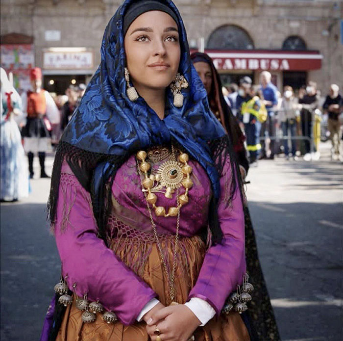 Young woman in traditional attire at a public event, representing the family of babysitter fatally hit by Lufthansa CEO's wife