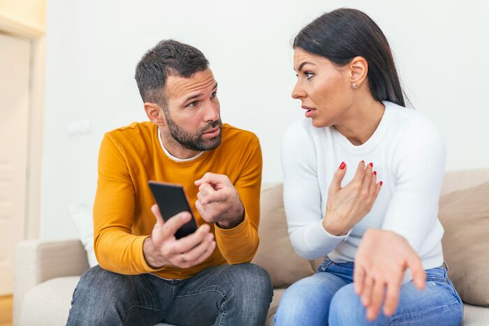 Man and woman having a serious conversation about what makes a man instantly unattractive to women in a home setting.