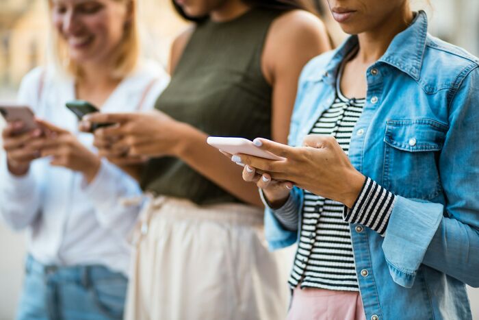 Three young women standing outdoors using smartphones, illustrating the internet on the brink of collapse. - 4