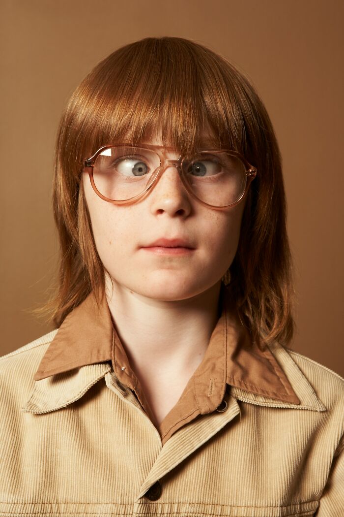 Young person with crossed eyes and glasses, highlighting mysterious body quirks causing curiosity and questions.