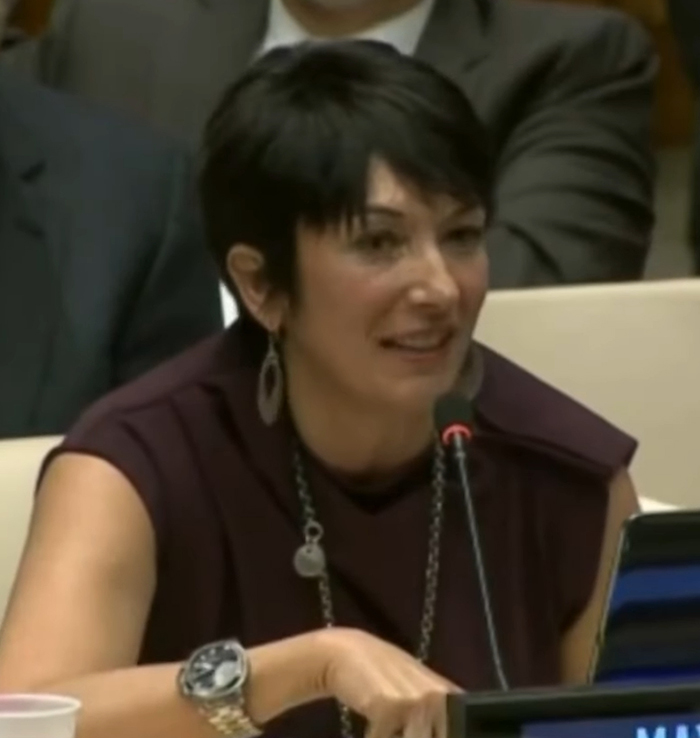 Ghislaine Maxwell speaking at a conference, with a microphone and audience in the background. Ghislaine Maxwell speaking at a conference, with a microphone and audience in the background.