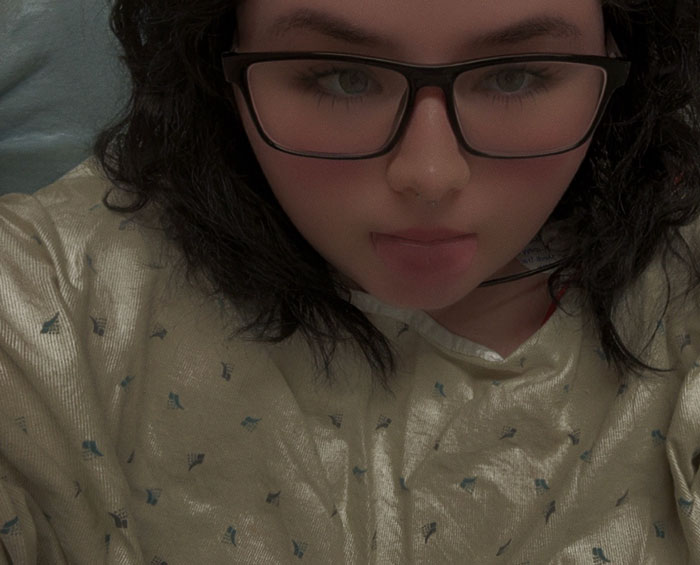 Teen girl indoors wearing glasses and a light shirt, illustrating teen zapped by lightning inside house using phone. Teen girl indoors wearing glasses and a light shirt, illustrating teen zapped by lightning inside house using phone.