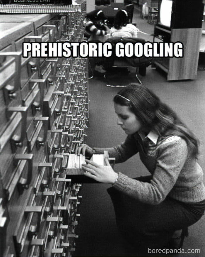 Woman using a card catalog in a library, representing nostalgic good old days of the 1980s.