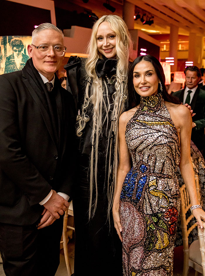 Three stars posing at an event, highlighting unexpected super tall celebrities featured in the height spotlight over 6 feet.