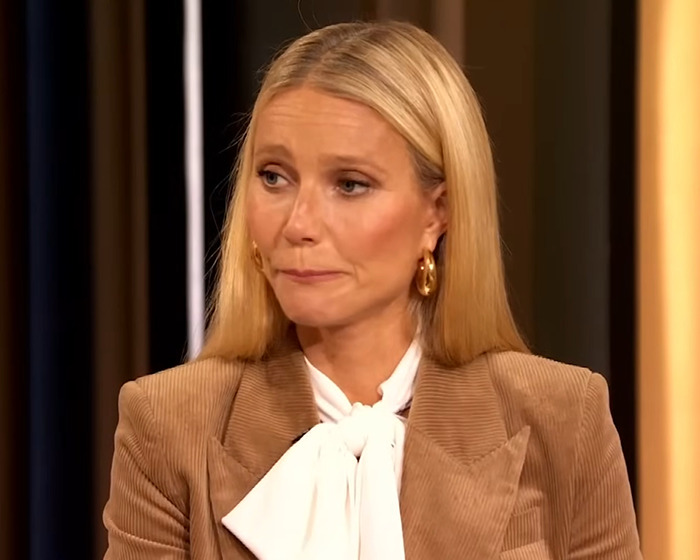 Gwyneth Paltrow wearing a brown blazer and white blouse, appearing emotional while discussing her toxic friendship with Madonna. - 9