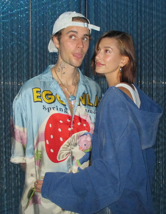 Hailey Bieber with Justin Bieber at an event, highlighting Stephen Baldwin's reaction to Rhode sale amid family rift.