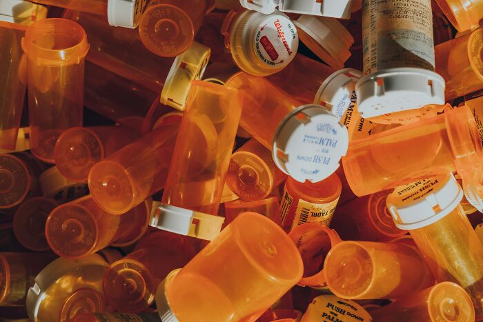 Multiple empty and partially used orange prescription pill bottles scattered, highlighting antidepressant withdrawal risks.