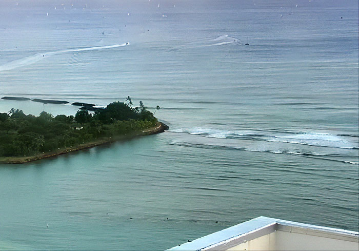 Coastal view of calm ocean waters and small island, illustrating the setting for an oncoming tsunami escape scenario. - 3