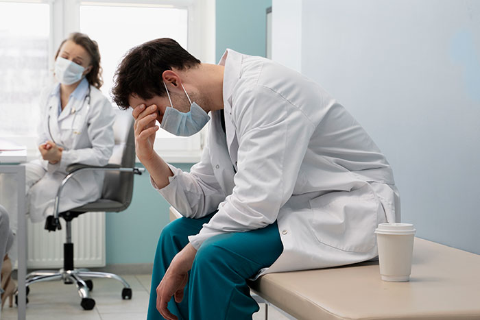 Tired hospital staff in masks share emotional moments reflecting the wildest things they've witnessed in healthcare.