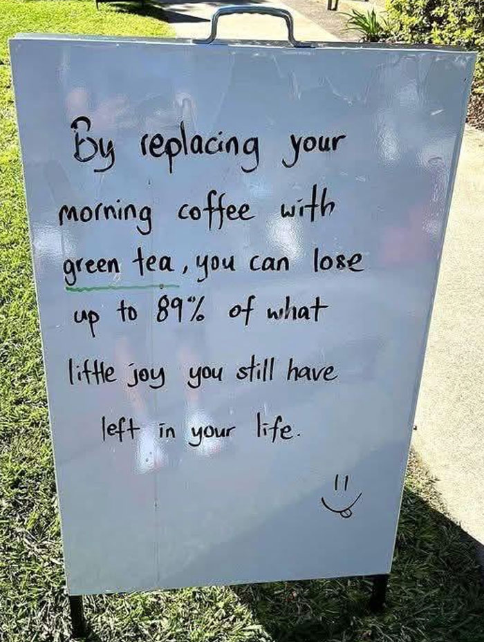 Funny handwritten sign humorously advising to keep morning coffee instead of green tea, showcasing hilarious dad humor.