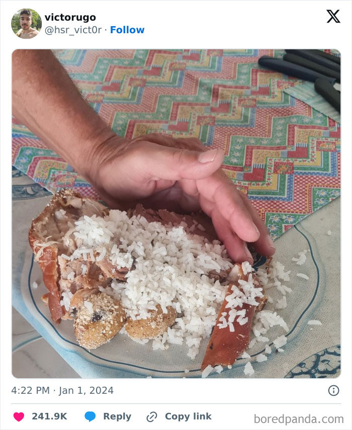 Hilarious dad serving a plate of rice and fried fish, showcasing funny moments of nailing fatherhood with creative meals.