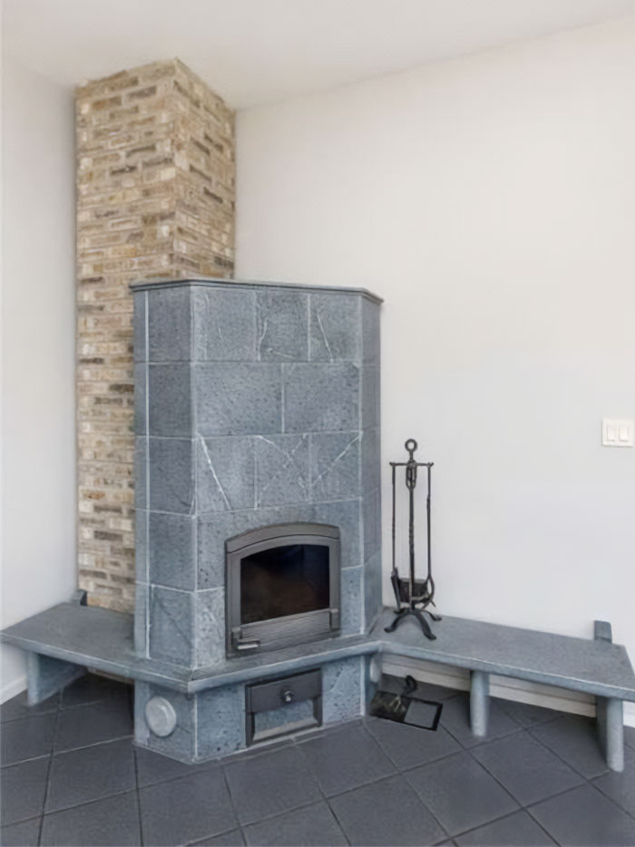 Modern gray stone fireplace with bench seating in a minimal home interior showing creative design fails.