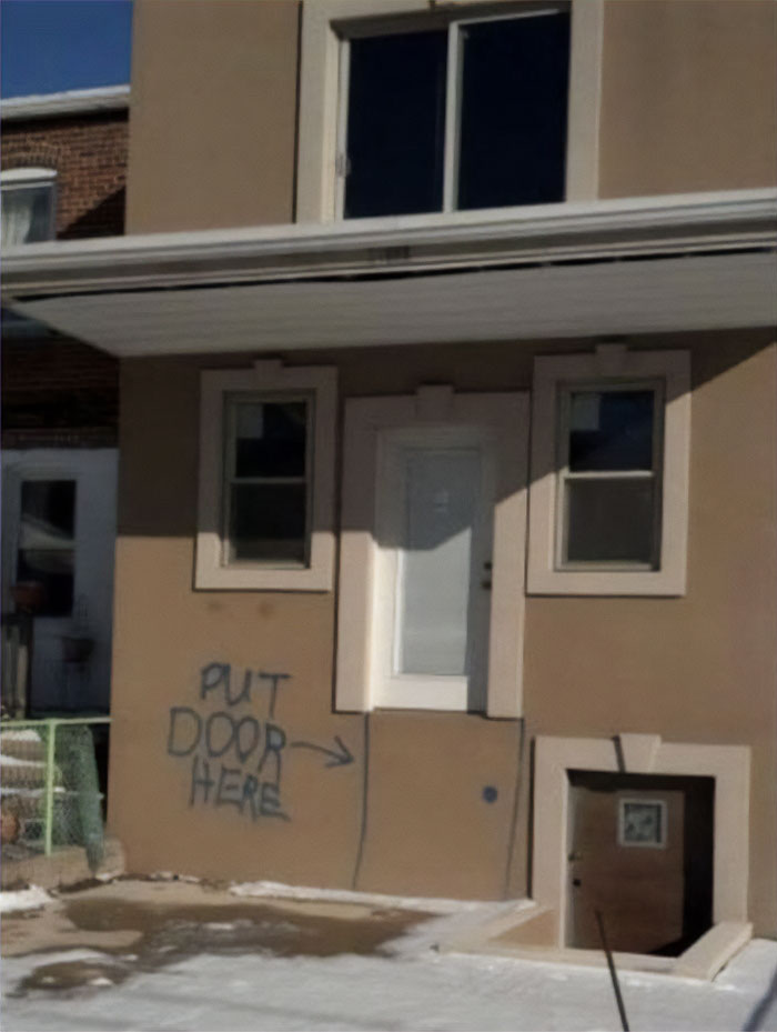 Home creativity fail showing a door placed with no stairs and graffiti indicating where the door should be.