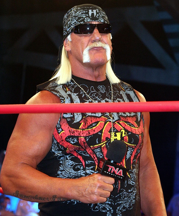 Hulk Hogan holding a microphone inside wrestling ring during press conference discussing pro wrestler's final moments.