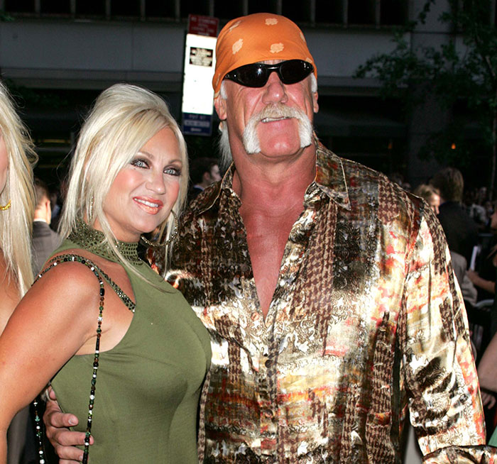 Hulk Hogan at a public event with a woman, wearing sunglasses and an orange bandana, highlighting pro wrestler's final moments.