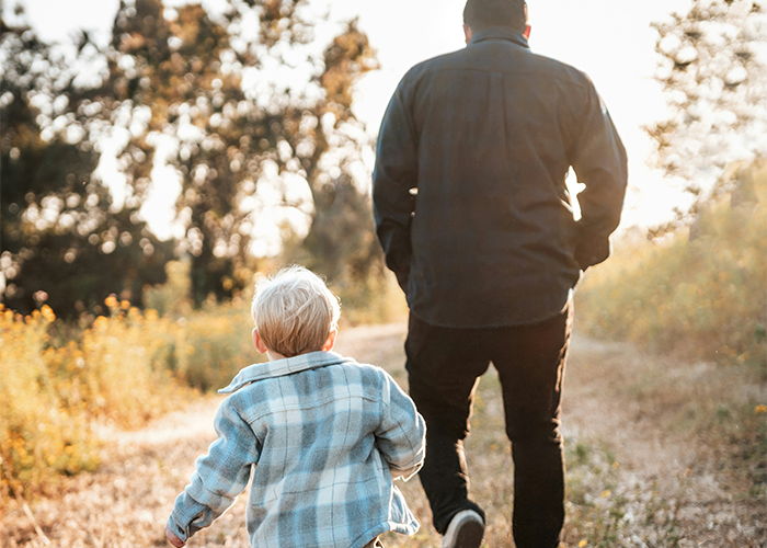 Man and child walking apart on a nature path, symbolizing marriage struggles and a mom feeling like she failed.