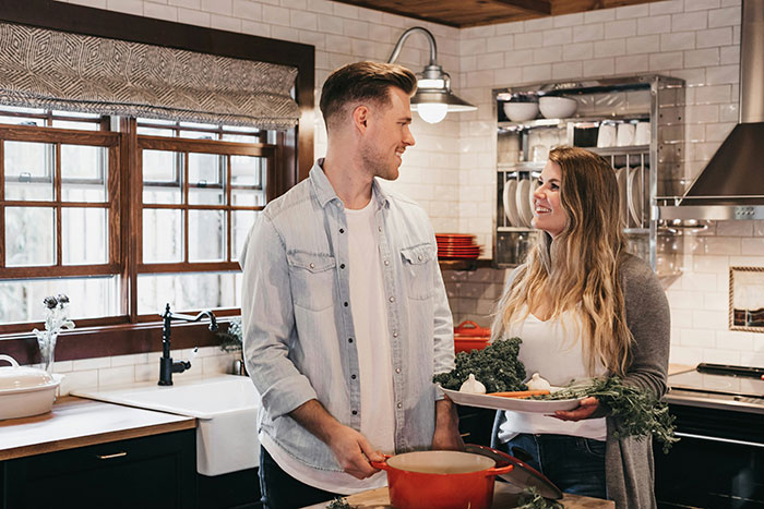 Couple sharing a tender moment in a kitchen, highlighting hubby's emotional reunion with ex and wife's concerns.