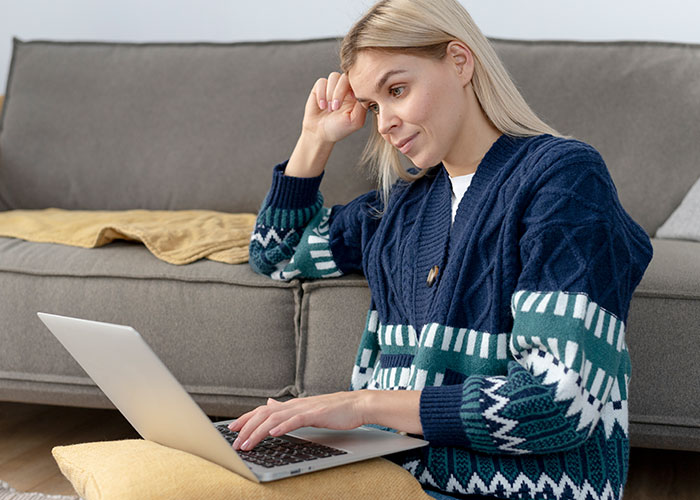 Woman exploring internet on laptop, reflecting on manipulative relationship and gaining awareness at home. - 9