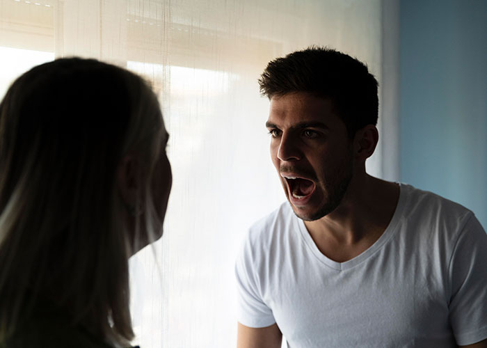 Woman confronting manipulative husband in a tense moment, symbolizing escape with the help of the internet and gained awareness. - 45