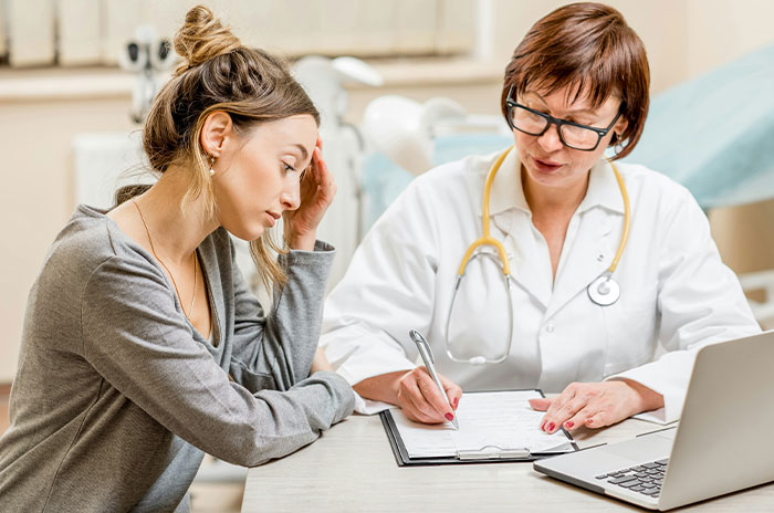 Woman consulting with a female doctor about kidney match results in a medical office setting during a health consultation. Woman consulting with a female doctor about kidney match results in a medical office setting during a health consultation.