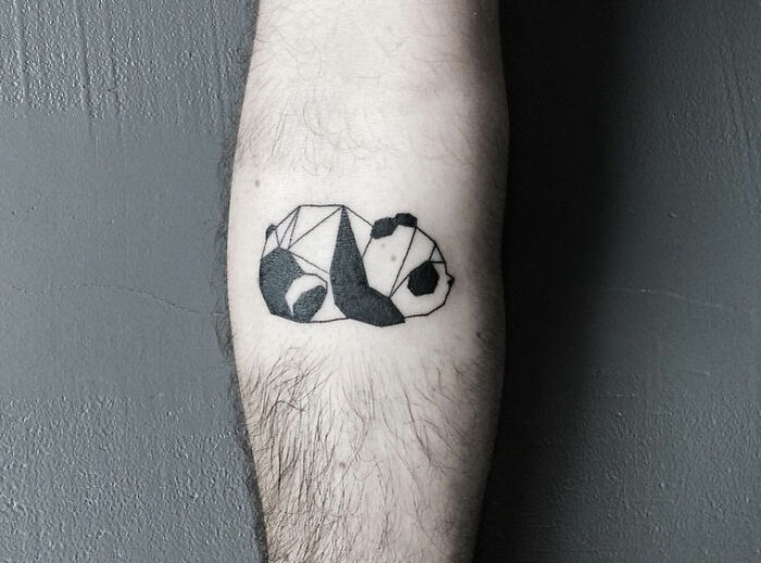 Geometric panda tattoo in black ink on a person's forearm showcasing one of the best tattoos appreciated by many.