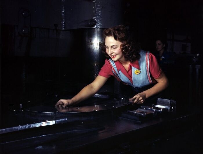 Woman worker during WWII in industrial setting, demonstrating the bold and brilliant role of women at work.