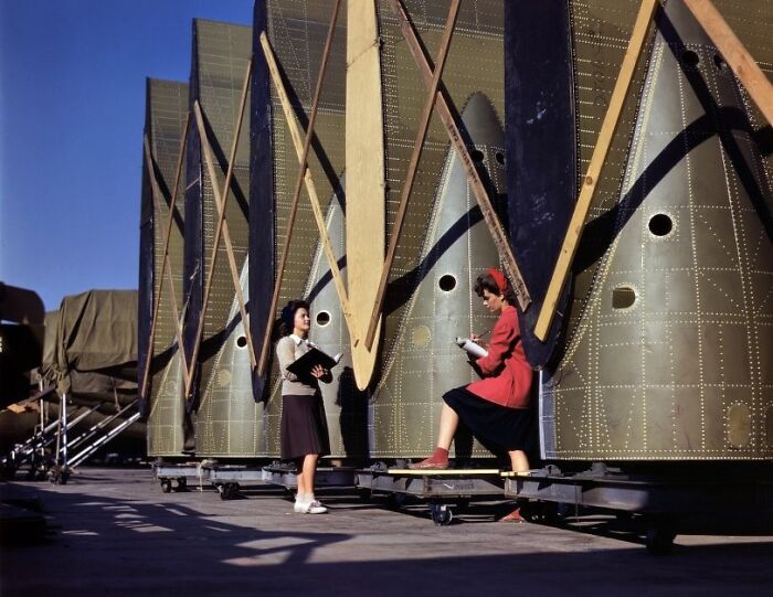 Women at work during WWII inspecting aircraft parts, showcasing the bold, brilliant roles in wartime industry.