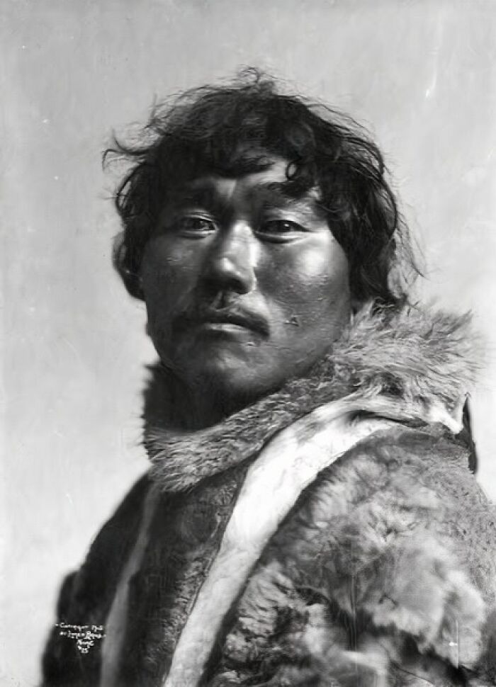 Portrait of an Inuit man wearing traditional fur clothing, showcasing the historic spirit of the Inuit people.
