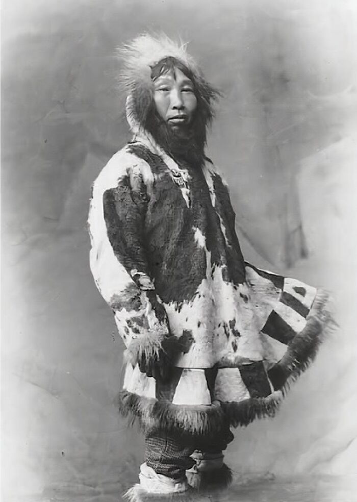 Historic photo of an Inuit person wearing traditional fur clothing, showcasing the spirit and culture of the Inuit community.