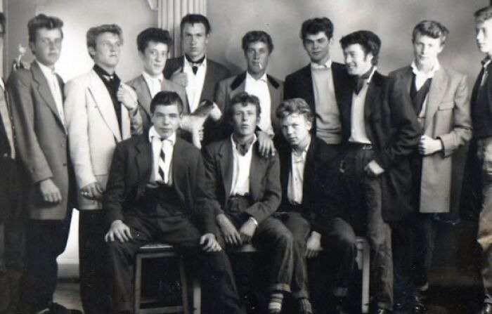 Group of young men dressed in classic 20th century Teddy Boy fashion posing for a black and white photo.