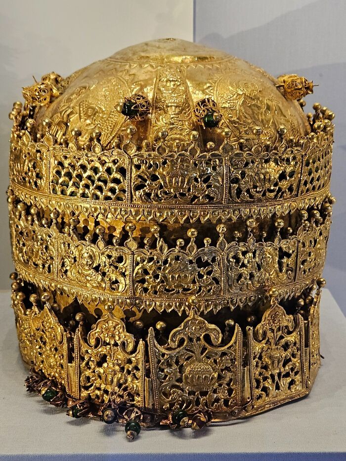 Intricately designed gold crown artifact from a foreign culture displayed among British Museum foreign artifacts collection.