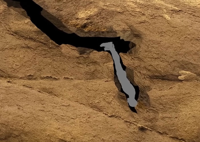 Silhouette of a person trapped in a narrow rocky crevice, illustrating creepy true stories that haunt people.