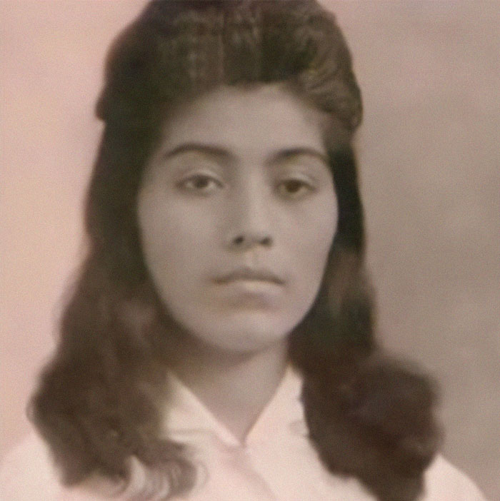 Vintage portrait of a woman with dark hair and serious expression, evoking creepy true stories that haunt people.