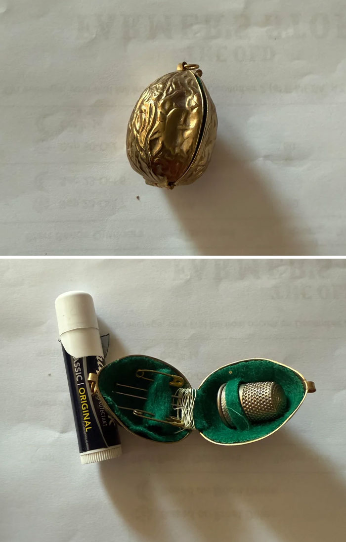 Small vintage sewing kit in a gold walnut case with thimble, needles, and safety pins, showing old interesting and beautiful items.