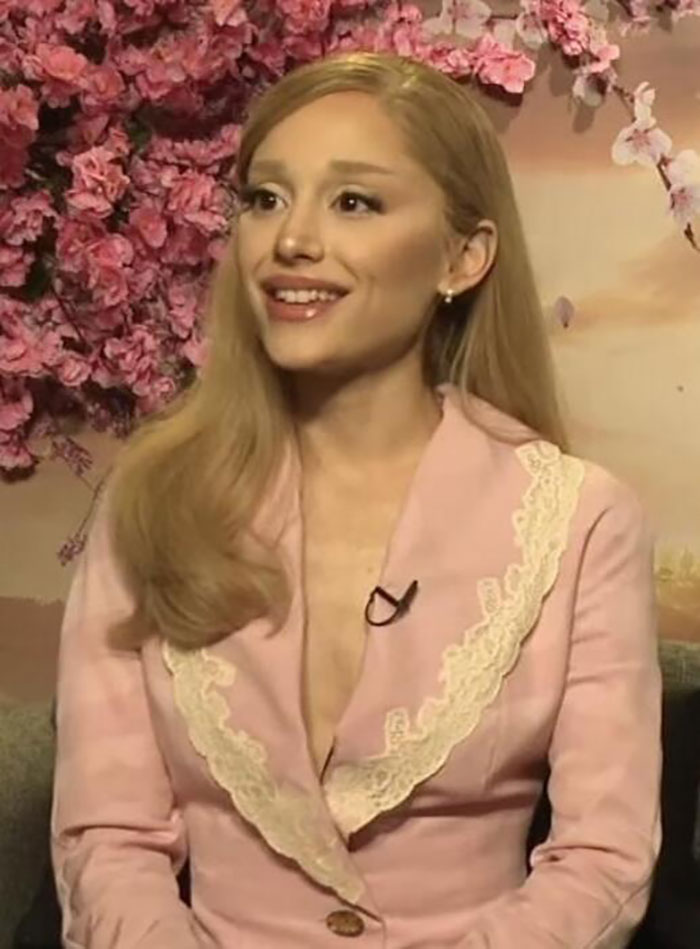 Young woman in a pink blazer smiling during an interview about favorite and awkward encounters with celebrities. - 29