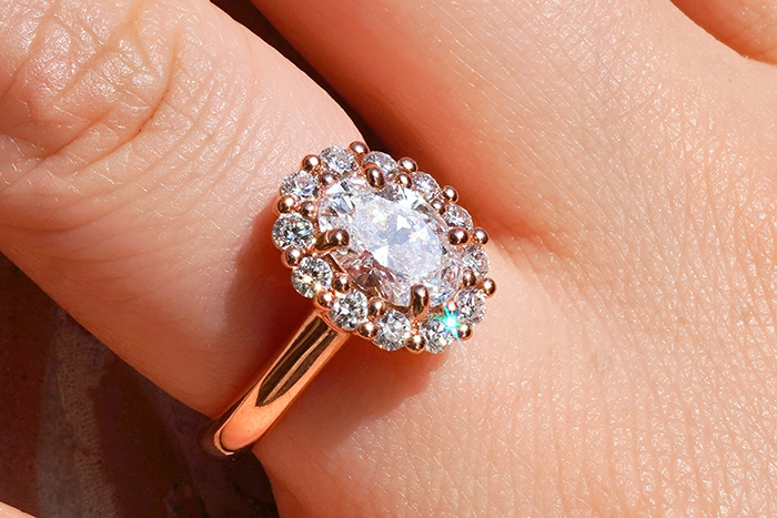 Close-up of a sparkling diamond ring on a finger, illustrating one of the cool facts about the world revealed this June.
