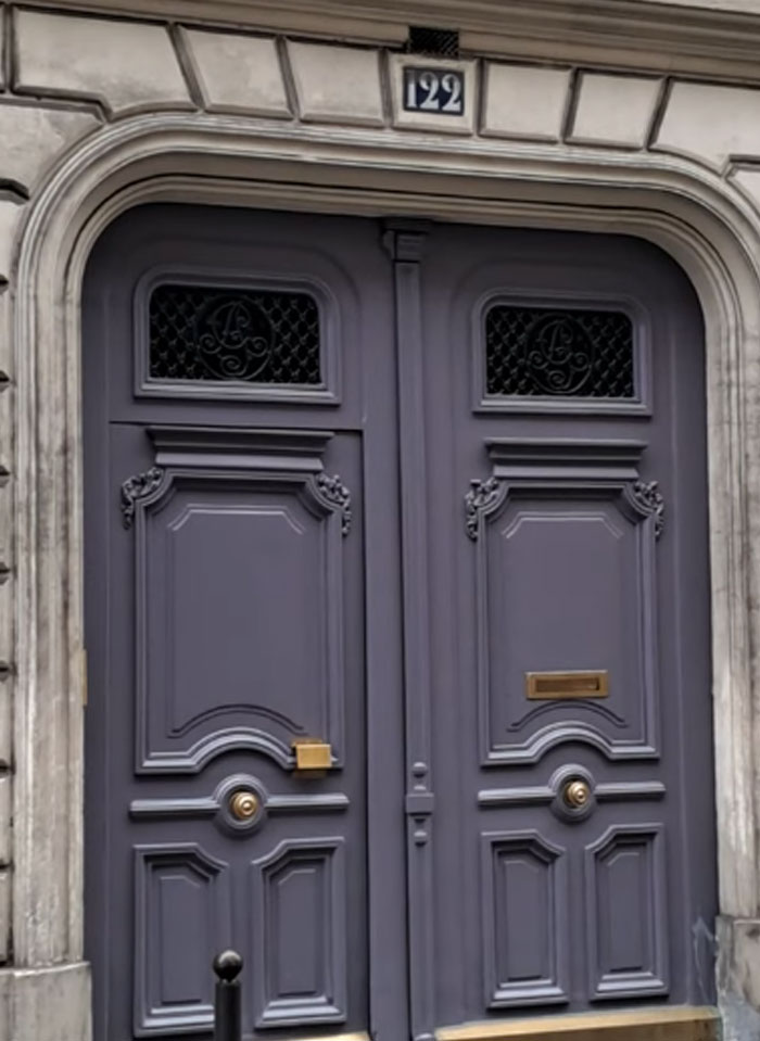 Ornate double doors with decorative panels and wrought iron details, showcasing cool facts about the world architecture.